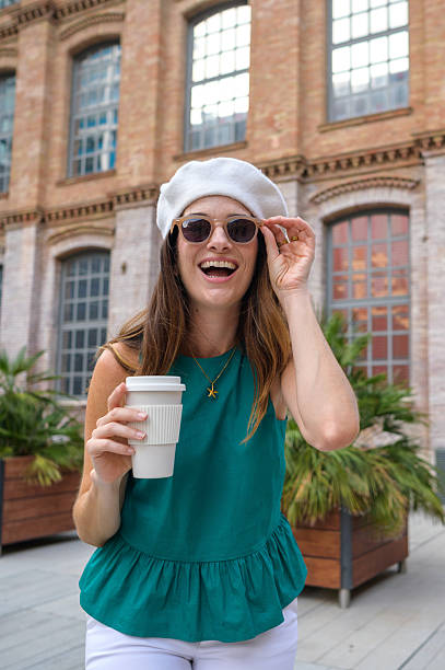 istock Happy tourist holding reusable coffee cup and smiling 2231531712