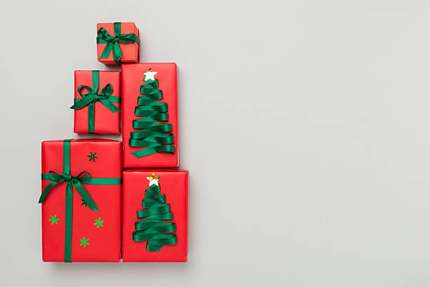 istock Gift boxes in Christmas tree shape on color background, top view 2231531806