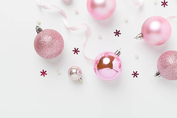 istock Pink christmas balls with decor on color background, top view 2231531814