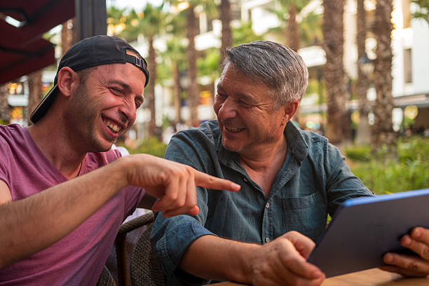 istock Digital Joy: Friends Sharing Laughter Over a Tablet 2231531893