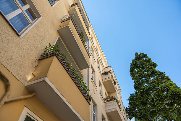 istock Yellow residential building with balconies and flower boxes. 2231532251