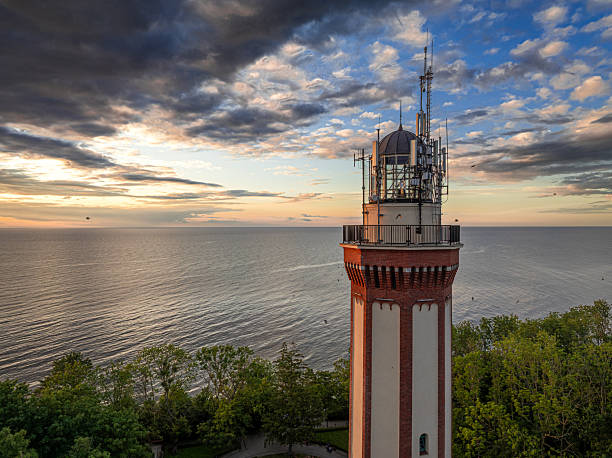 istock Beautiful sunset over the sea with a lighthouse. 2231535568