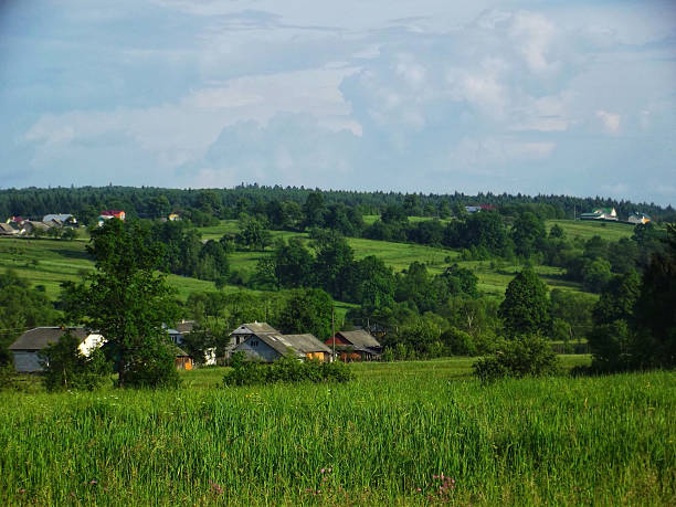 An idyllic and charming remote village, cradled by lush green hills and distant peaks