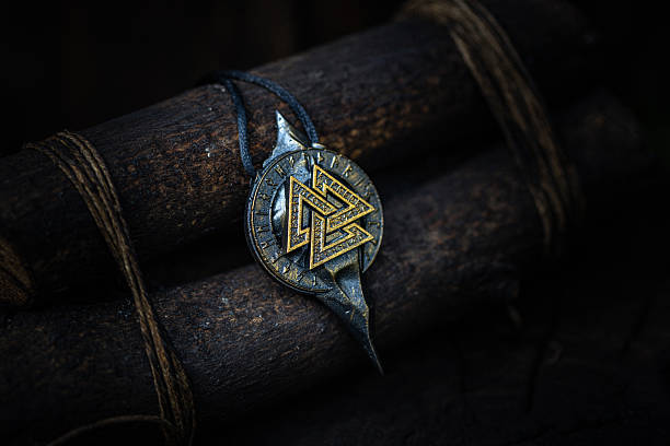 istock Ancient Nordic Symbol - Valknut Rune Design on dark aged background 2231539588
