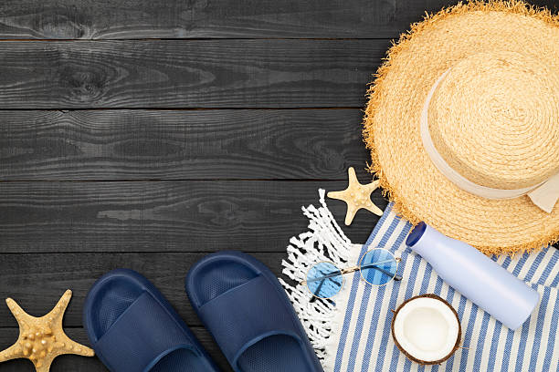 istock Blue beach accessories on wooden background, top view. Copy space for text 2231540056