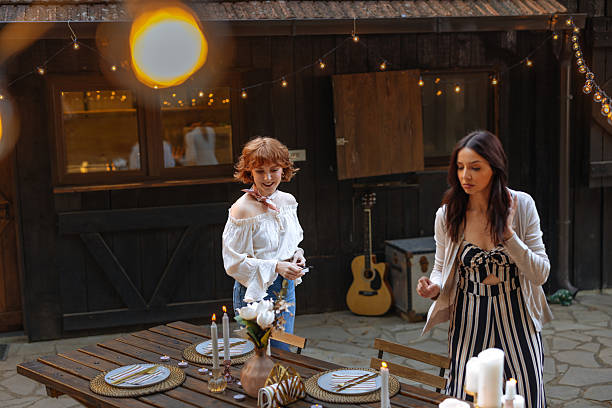 istock Two women setting up a table for a backyard dinner party 2231540859