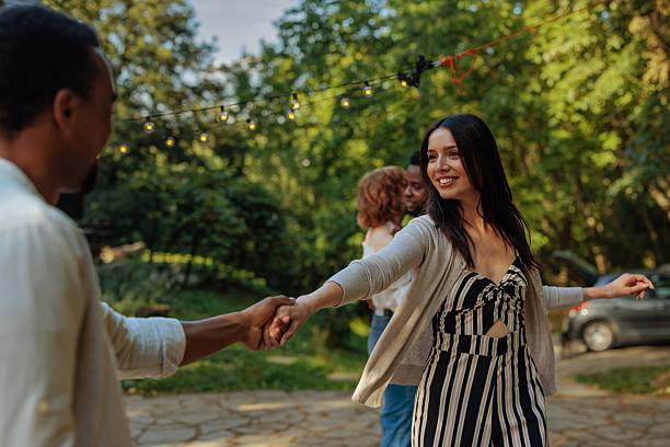 istock Stylishly dressed woman dancing with a young black man 2231540868
