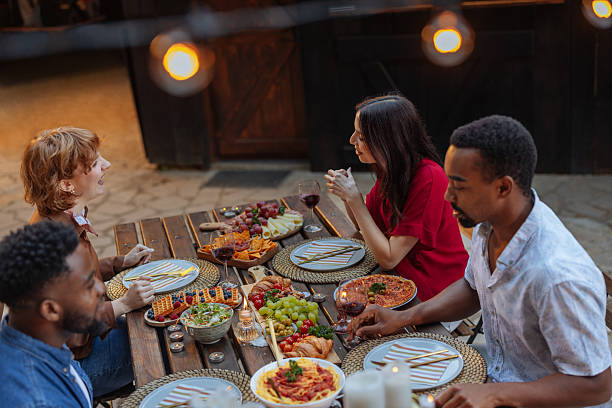 istock Four people enjoying a cozy, private dinner party 2231540872