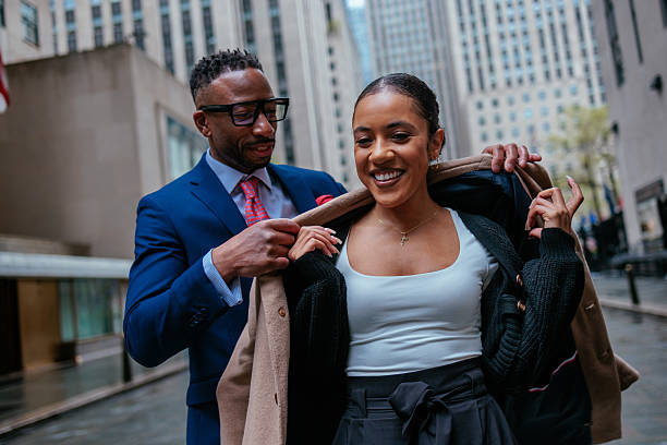 istock Man helping woman put on a coat 2231540907