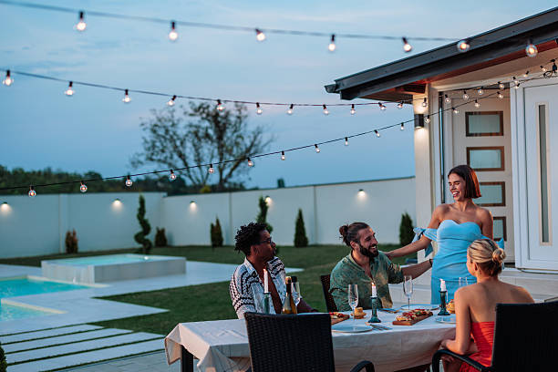 istock Friends enjoying dinner party in backyard with swimming pool 2231540968