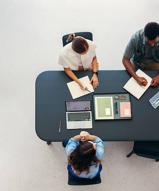 istock Overhead View of a Collaborative Business Team Meeting in Office Setting 2231544635