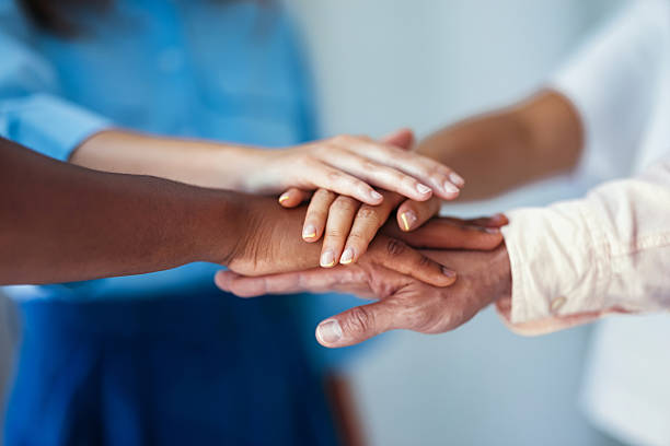 istock Group of Individuals Joining Hands to Represent Unity and Collaboration 2231544700