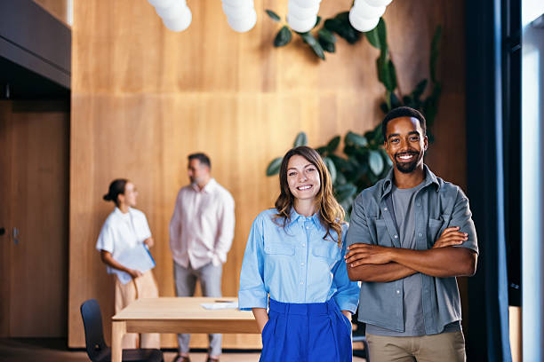 istock Diverse Team Members Standing in a Modern Office Environment Smiling 2231544738