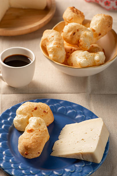 istock Cheese bread, table with coffee cheese bread and semi-cured cheese from Brazil, selective focus. 2231545048
