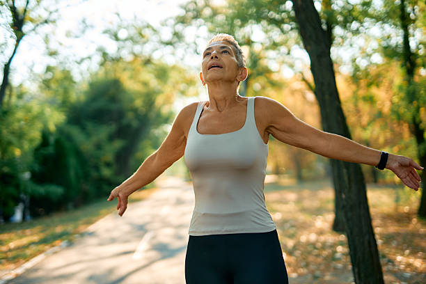 istock Senior woman breathing fresh air while exercising in a park 2231546778