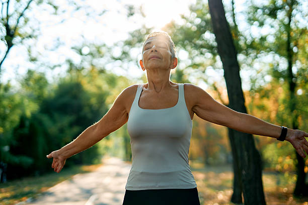istock Senior woman breathing fresh air while exercising in a park 2231546789
