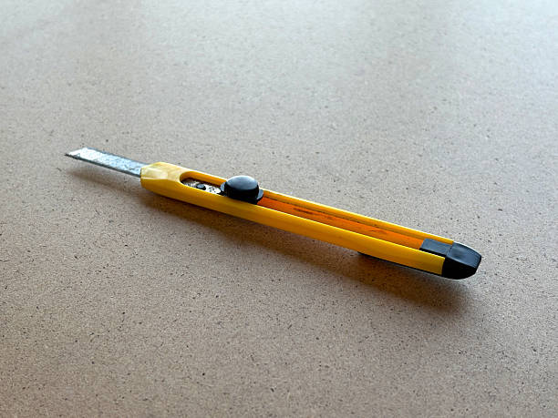 An obsolete utility knife on the wood background with copy space
