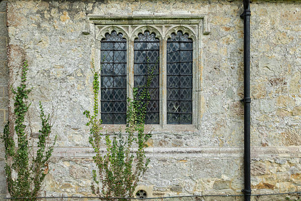 istock Historic church Stone Wall With Vine-Covered Gothic Window 2231549966