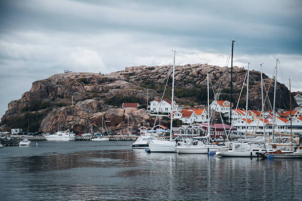 Small colourful boathouses of Smogen with boats anchored at the jetty, Smogen, Sotenas municipality, Vastra Gotaland county, Bohuslan, West Sweden, Sweden, Scandinavia, Europe