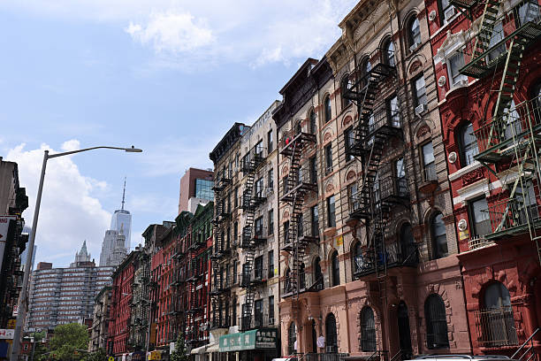 Lower Manhattan, New York. Taken July 17,  2025. Row of townhouses in chinatown lower Manhattan - with view of the freedom tower in the background.