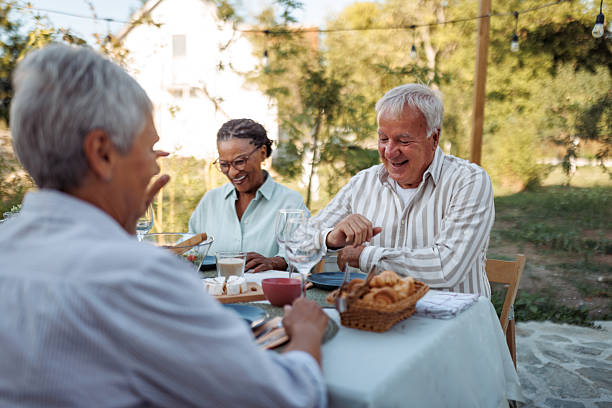 istock Three senior friends enjoying backyard party together 2231560846