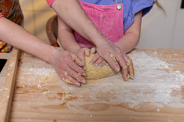 istock Hands methodically knead dough in a warm, cozy kitchen thats filled with love, joy, and creativity 2231560964