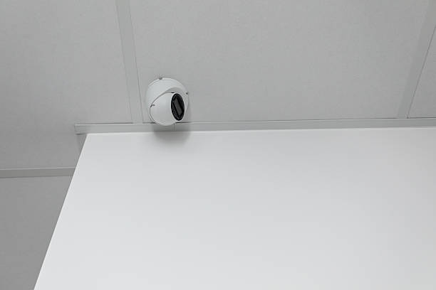 istock Surveillance Camera Strategically Mounted on Ceiling in a Clean, Minimalist Setting and Design 2231563147