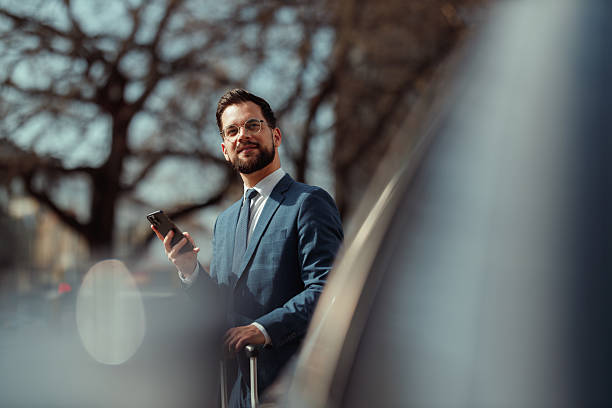 Businessman With Suitcase Checking Phone