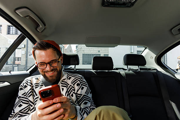 istock Man Having Video Call in Car Backseat 2231565594
