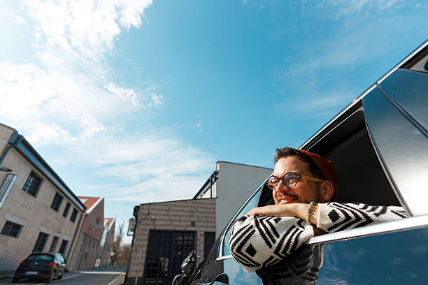 istock Excited Man Celebrating from Car Window 2231565597