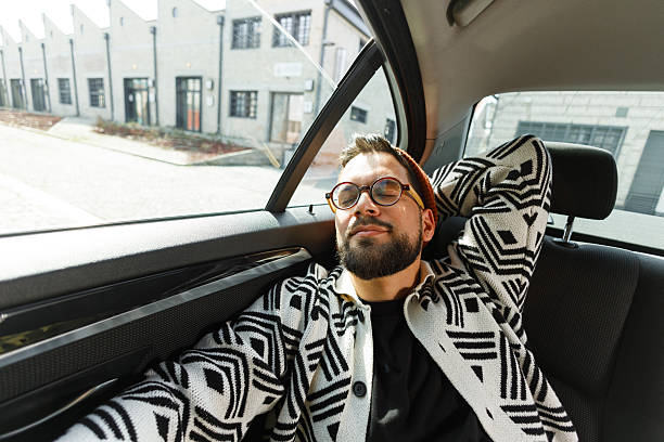 istock Stylish Man Relaxing in Car Backseat 2231565604