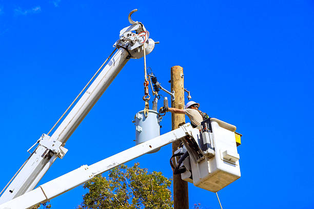 istock Utility worker repairs electrical equipment on power pole during clear day 2231571040