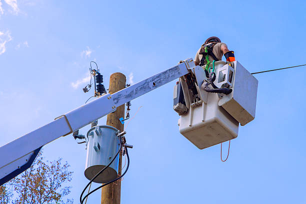 istock Electrical worker performs maintenance on power lines using bucket truck in bright daylight 2231571042