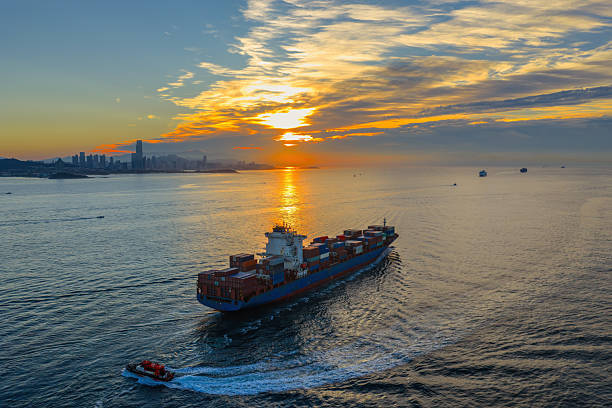 istock The cargo ship is approaching the port with the tugboat 2231573033