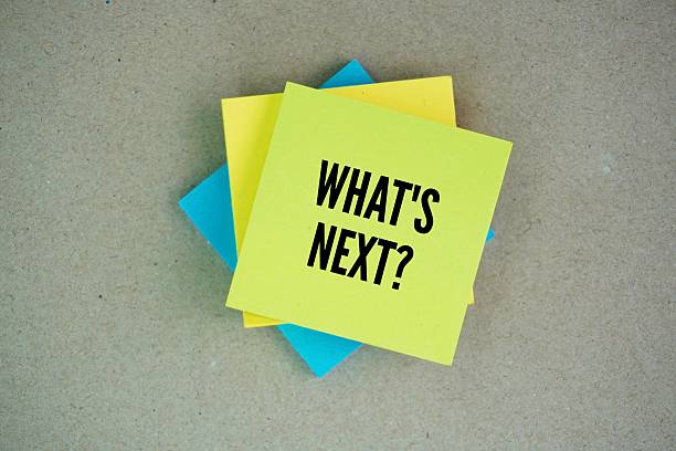 istock colored paper with the question word What's Next? next step concept. coming immediately after the time of writing or speaking. 2231576875