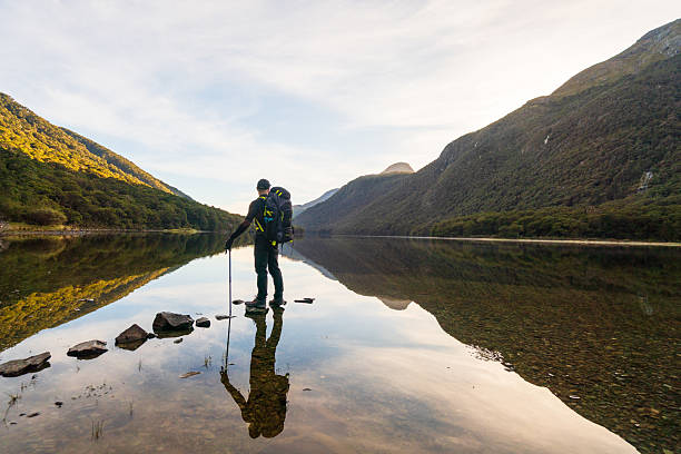 istock Explorer trekking over water rocks in natural landscape. 2231582192