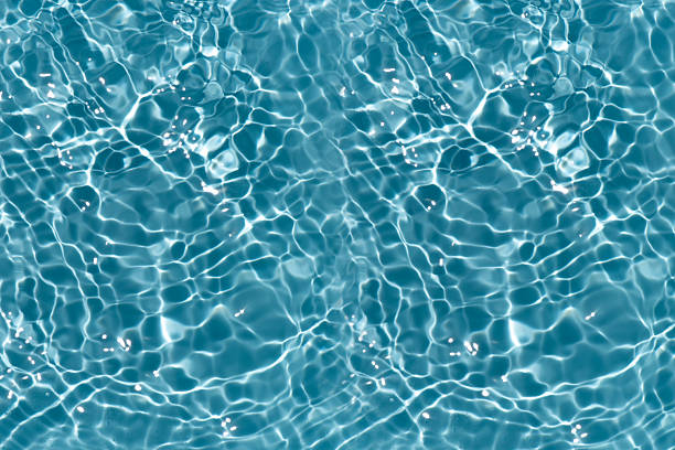 istock Blue water with ripples on the surface. Defocus blurred transparent blue colored clear calm water surface texture with splashes and bubbles. Water waves with shining pattern texture background. 2231583151