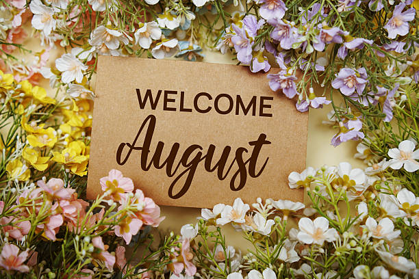 istock Welcome August text message with flower decoration on yellow background 2231585691