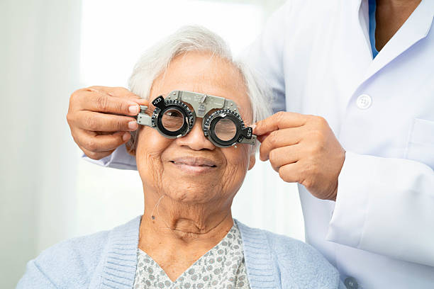 istock Optometrist checking Asian elderly woman ophthalmic vision eye test and using optical trial frame. 2231586004