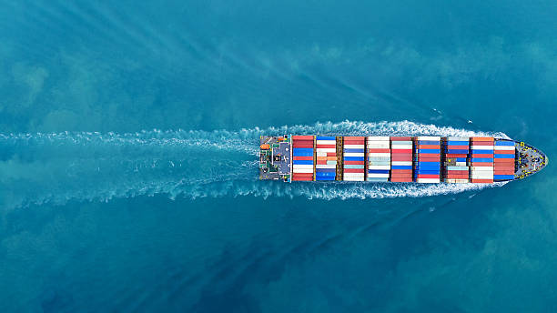 istock Aerial of cargo ship carrying container and running verry fast for export cargo from cargo yard port to other ocean concept smart freight shipping ship top view 2231587032