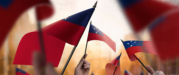 istock Samoa flags in their hands on a blurred urban background 2231587755