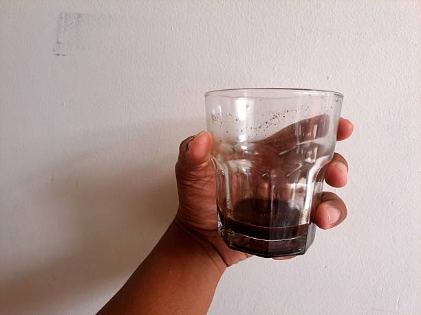 istock hand holding an empty coffee cup. hand holding glass. used coffee cup. 2231589174