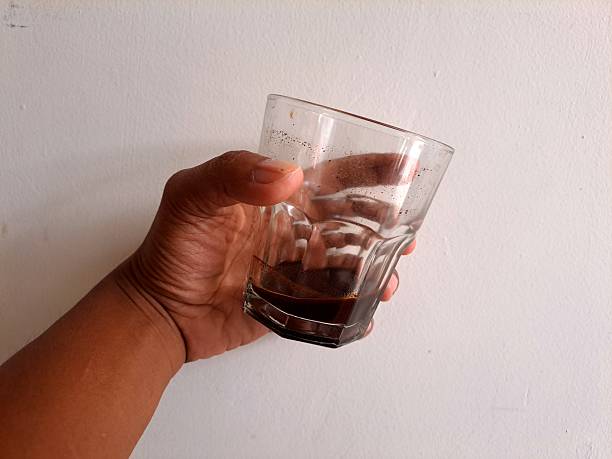 istock hand holding an empty coffee cup. hand holding glass. used coffee cup. 2231589175