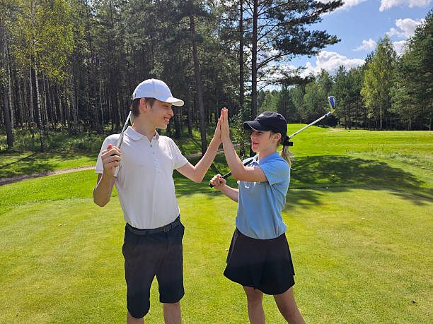 istock Golfers celebrate a successful shot on a sunny day at a green course 2231589520