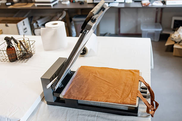Silkscreen Printing Press Setup with Blank Cotton Tote Bag in Textile Workshop