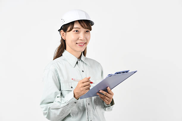 istock A young Asian woman in work clothes holding a board 2231597608