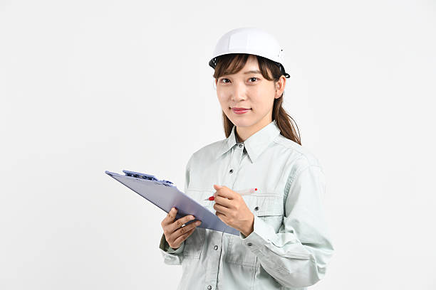 istock A young Asian woman in work clothes holding a board 2231597611