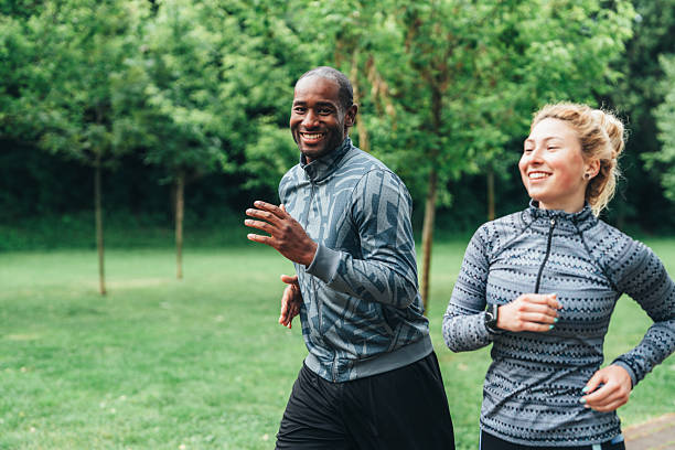 istock Cardio training outdoors. Happy athletic couple having fun while running together in nature. 2231597881