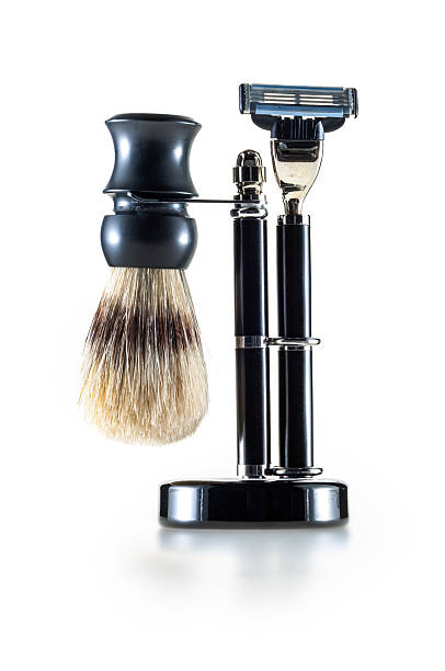 Shaving brush and razor in a standard, isolated on white background. Studio shot.