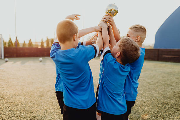 istock Junior football team celebrating victory 2231605559